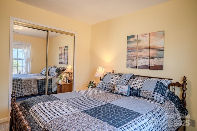 bedroom featuring carpet and a closet