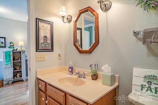 bathroom with vanity and wood finished floors