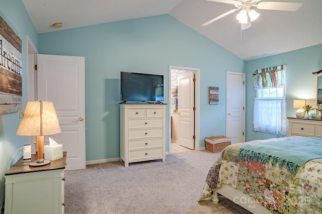 bedroom with lofted ceiling, ceiling fan, connected bathroom, light colored carpet, and baseboards