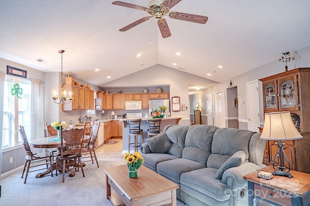 living area featuring lofted ceiling, recessed lighting, ceiling fan with notable chandelier, light colored carpet, and visible vents