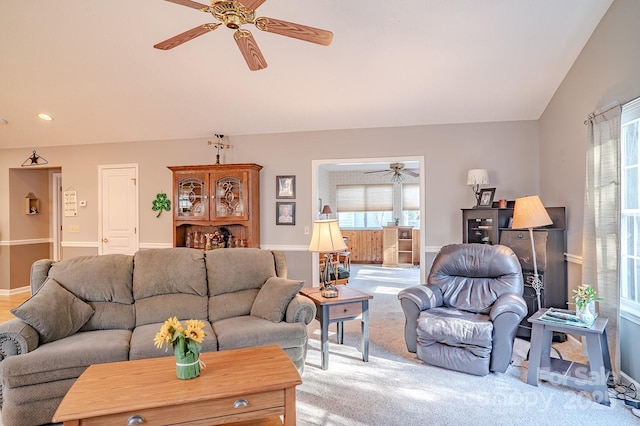 living area with lofted ceiling, recessed lighting, a ceiling fan, light carpet, and baseboards