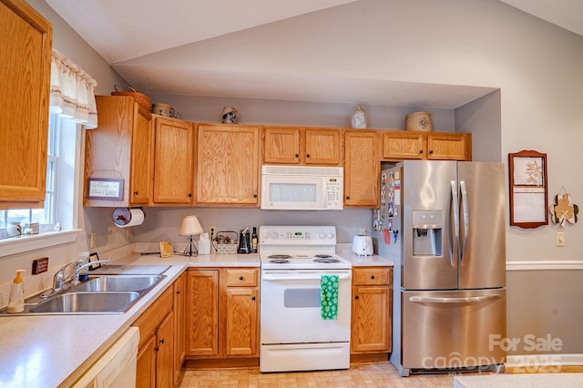 kitchen with lofted ceiling, light countertops, white appliances, and a sink