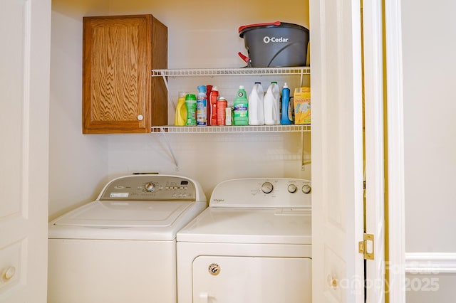 laundry area with cabinet space and washer and clothes dryer