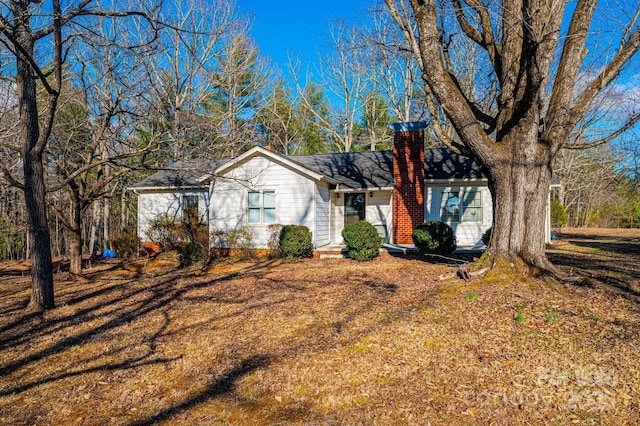 ranch-style home featuring a chimney