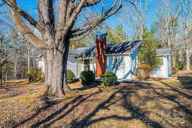 view of front of house with a front lawn and a chimney