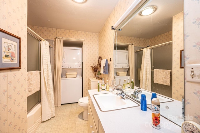 full bathroom with shower / tub combination, toilet, stacked washer and dryer, vanity, and wallpapered walls