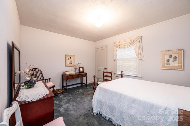 bedroom with dark colored carpet and baseboards