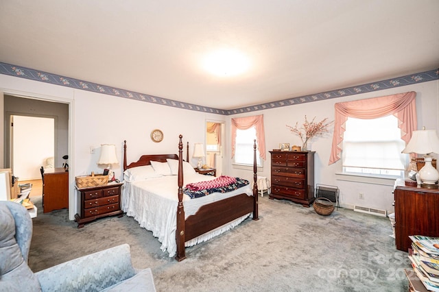 bedroom with multiple windows, carpet flooring, and visible vents