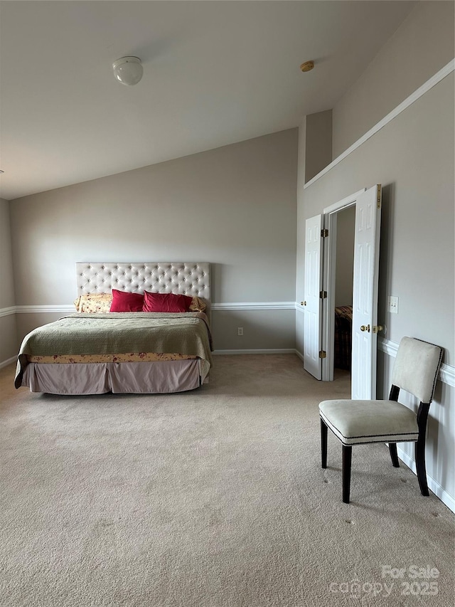 bedroom featuring carpet floors, lofted ceiling, and baseboards