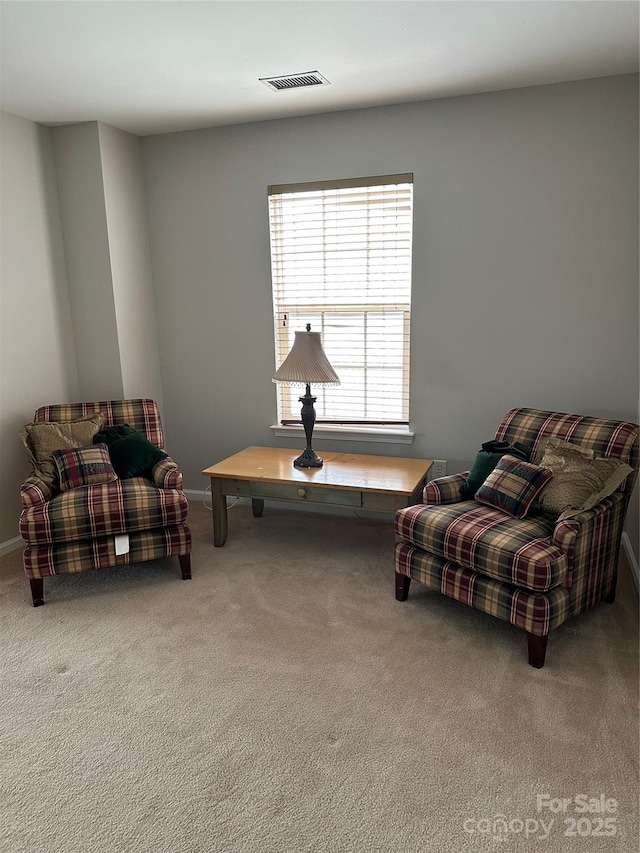 living area with carpet and visible vents