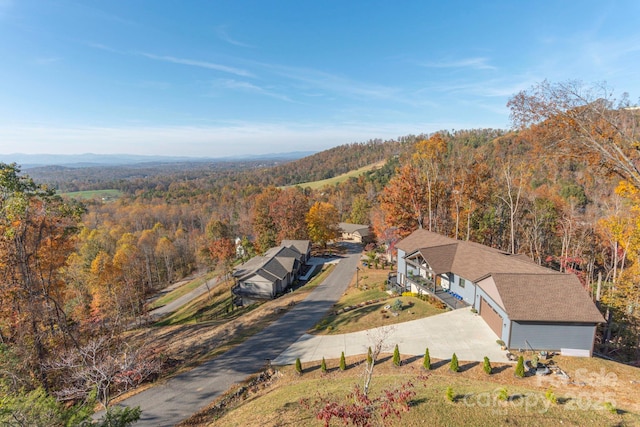 aerial view with a mountain view and a view of trees