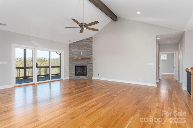 unfurnished living room featuring a fireplace, light wood finished floors, high vaulted ceiling, beamed ceiling, and baseboards