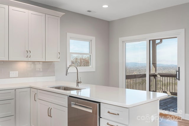 kitchen featuring a sink, white cabinets, dishwasher, and light countertops