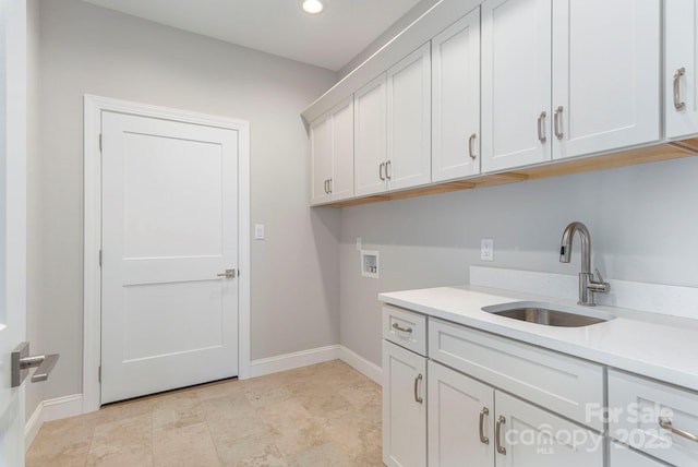 laundry area with hookup for a washing machine, recessed lighting, a sink, baseboards, and cabinet space