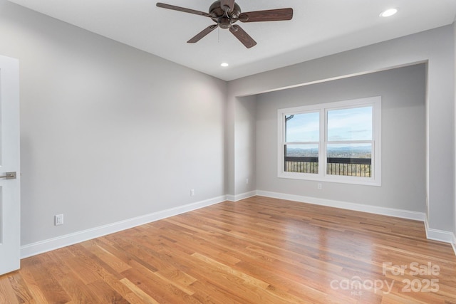 spare room featuring a ceiling fan, recessed lighting, light wood-style flooring, and baseboards