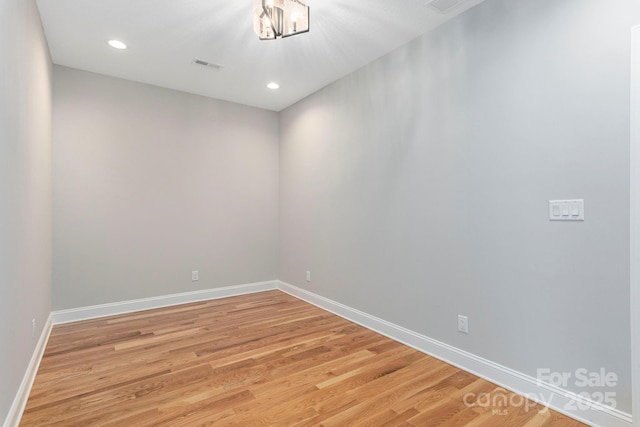 empty room featuring recessed lighting, baseboards, visible vents, and light wood finished floors