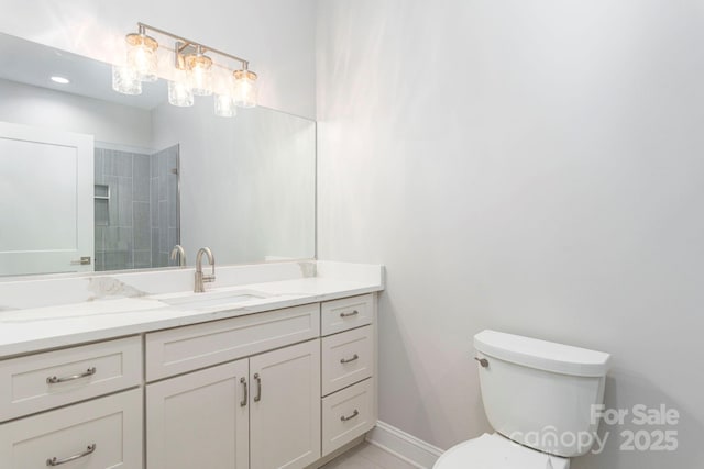 full bath featuring baseboards, vanity, and toilet