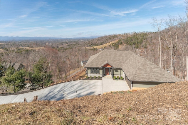 exterior space with a wooded view