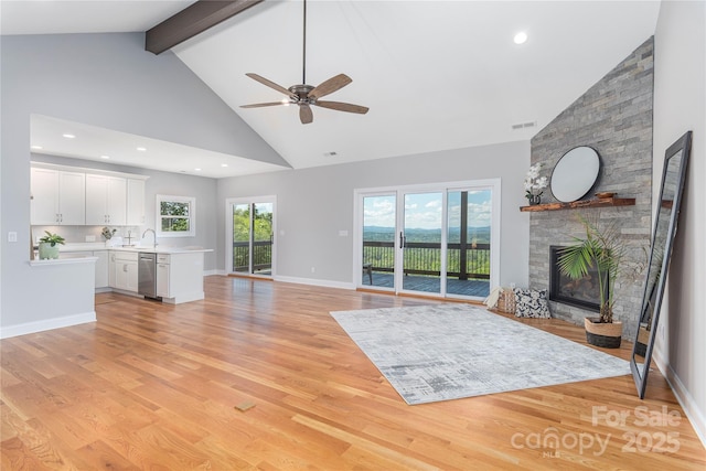 54 Herron View Ln, Weaverville, NC 28787 - unfurnished living room featuring high vaulted ceiling, ceiling fan, light wood-type flooring, a fireplace, and beamed ceiling