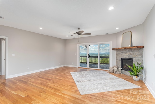 54 Herron View Ln, Weaverville, NC 28787 - unfurnished living room with a ceiling fan, a stone fireplace, light wood finished floors, and recessed lighting