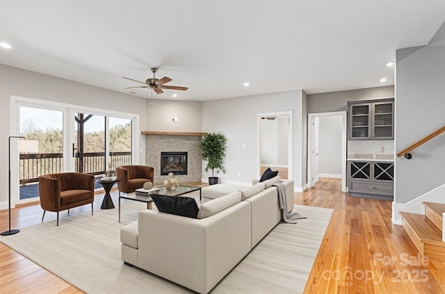 54 Herron View Ln, Weaverville, NC 28787 - living area featuring stairway, ceiling fan, a glass covered fireplace, light wood-style floors, and recessed lighting