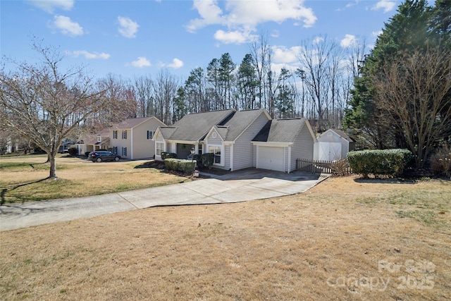 view of front of property featuring driveway, a garage, and a front lawn