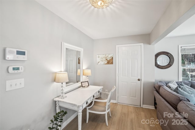 home office featuring baseboards and light wood-style floors