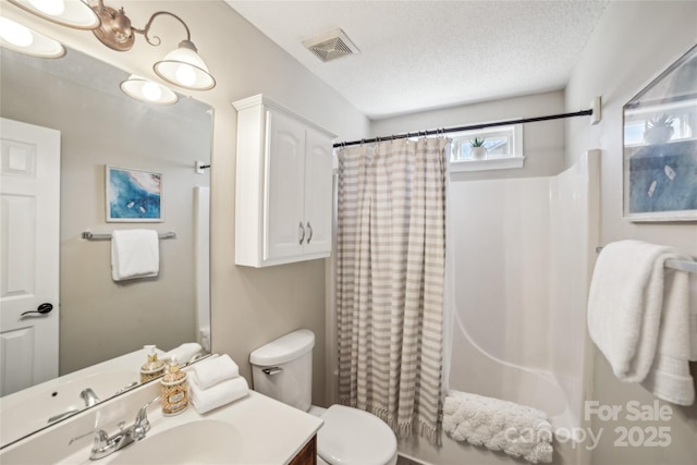 full bath featuring visible vents, toilet, shower / bath combo with shower curtain, a textured ceiling, and vanity