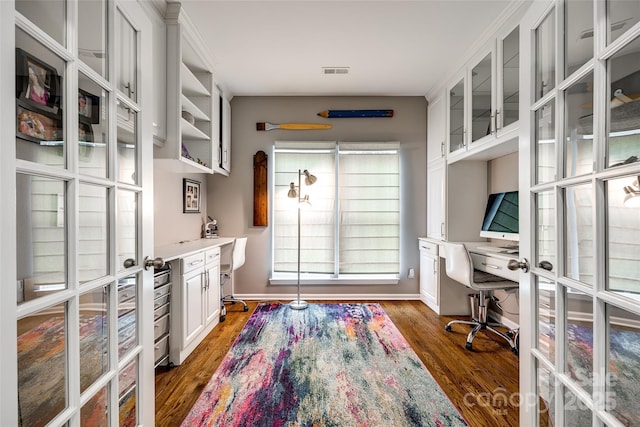 office space featuring baseboards, visible vents, built in study area, dark wood-type flooring, and french doors