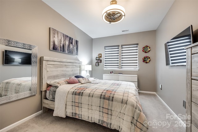 bedroom featuring light carpet, visible vents, and baseboards