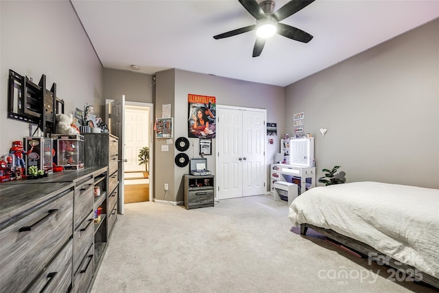 carpeted bedroom featuring ceiling fan and a closet