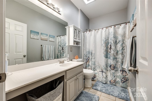 full bathroom featuring toilet, vanity, and tile patterned floors