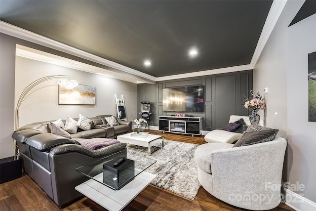 living room with dark wood finished floors, crown molding, baseboards, and recessed lighting