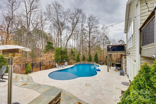 view of swimming pool with a patio area, fence, and a fenced in pool