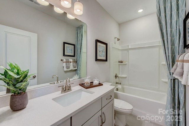 bathroom featuring shower / bath combination with curtain, visible vents, vanity, and toilet