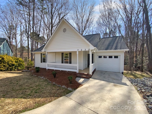 view of front of house with covered porch, roof with shingles, driveway, and an attached garage