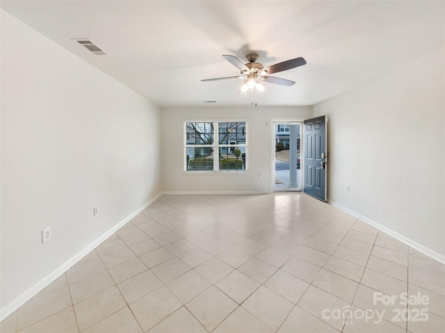 spare room with a ceiling fan, visible vents, baseboards, and light tile patterned floors