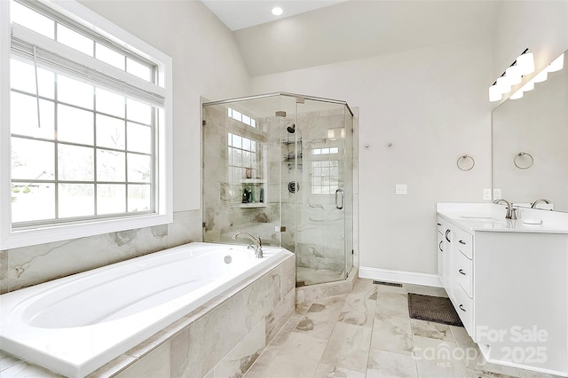 bathroom with marble finish floor, a stall shower, baseboards, a bath, and vanity