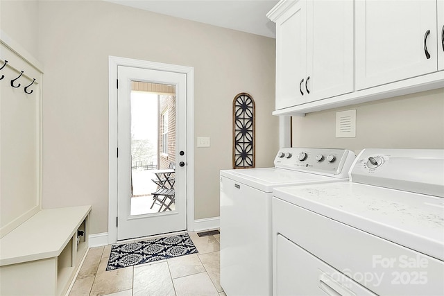 laundry room with washer and dryer, baseboards, and cabinet space