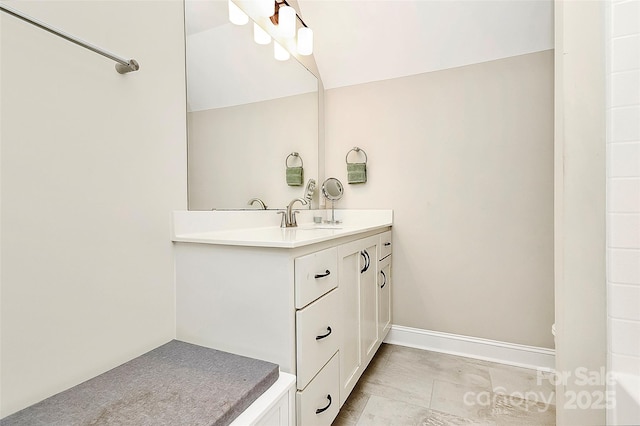 bathroom with vanity and baseboards