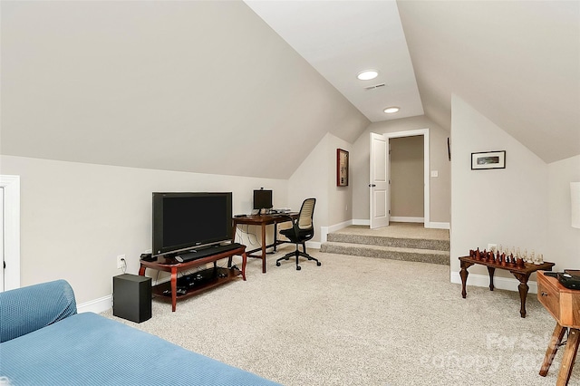 office featuring visible vents, baseboards, light colored carpet, and vaulted ceiling