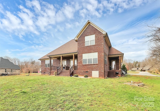 view of front facade featuring crawl space, central AC, a front lawn, and brick siding