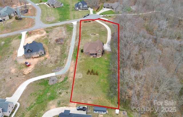 birds eye view of property with a residential view