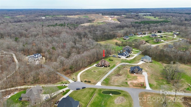 drone / aerial view with a wooded view