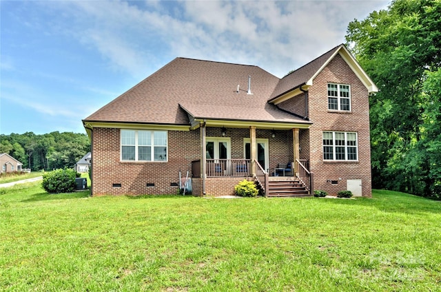 1011 Duntov Dr, Monroe, NC 28110 - view of front facade featuring crawl space, a front lawn, brick siding, a wooden deck, and roof with shingles