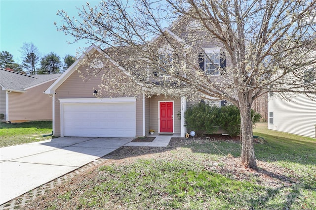 view of front of property featuring an attached garage, concrete driveway, and a front lawn