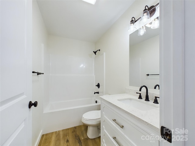 full bathroom with toilet, shower / bath combination, wood finished floors, and vanity