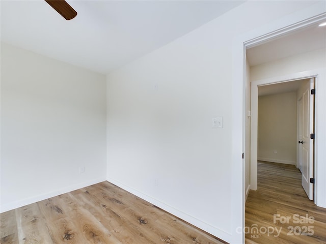 unfurnished room featuring a ceiling fan, baseboards, and wood finished floors