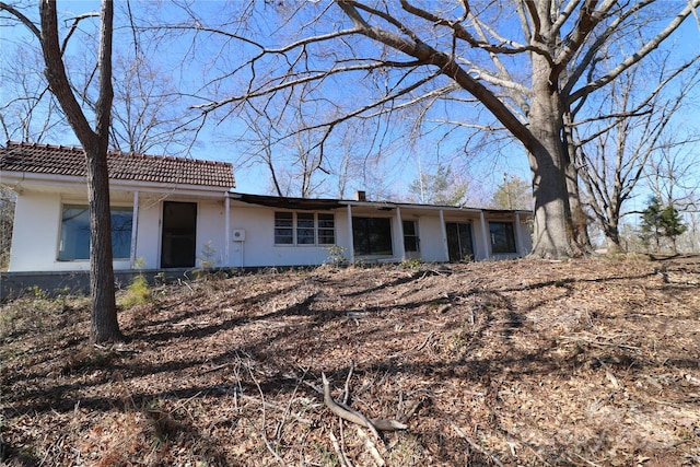 view of front of house featuring a tile roof and stucco siding