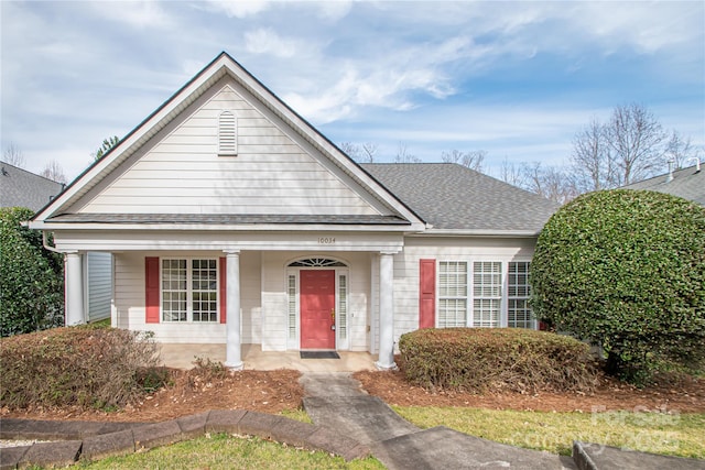 view of front of house with a porch and roof with shingles